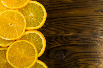 Fototapeta na wymiar Sliced oranges on wooden table