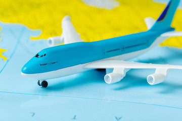 miniature of a passenger aircraft flying on a map
