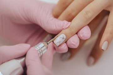 Manicurist with a milling cutter for manicure