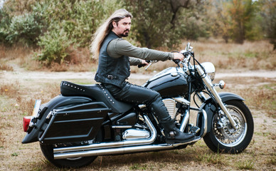 Fototapeta na wymiar Biker man with a motorcycle outdoor. 