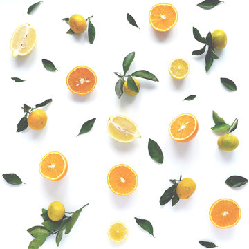 Food pattern of fresh fruit in a cut. Oranges, lemons slices , tangerines with green leaves. Composition from fruits, top view, flat lay. Citrus fruits background, wallpaper.
