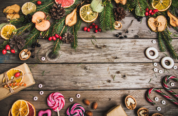 New Year composition of flowers, gifts, dried fruits on a wooden table. Christmas background. top view