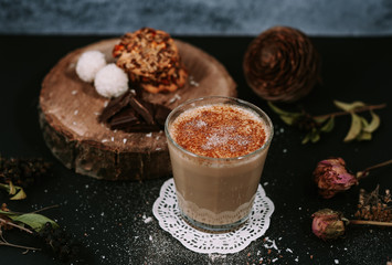 Hot cappuccino on rustic background