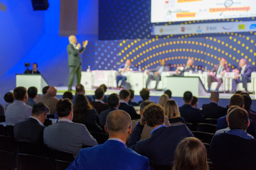 Audience listens to the lecturer at the conference hall