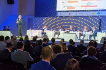 Audience listens to the lecturer at the conference hall