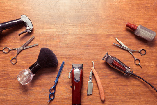 Top view of vintage barbershop tools on wooden background, flat lay overhead view