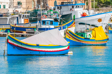 Fototapeta na wymiar Traditional Luzzu boat at Marsaxlokk harbor in Malta.