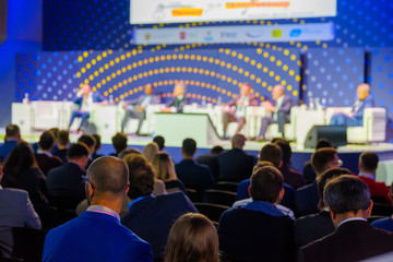 Audience listens to the lecturer at the conference hall