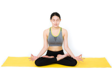 Fototapeta premium attractive beautiful woman sit on yellow seat pad try playing yoga in meditation pose on white background. healthy care concept.
