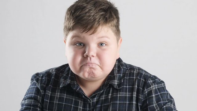 Young fat boy shows anger, aggression and hatred