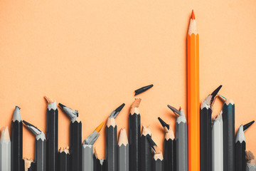 creative idea, the concept of the strength of a people character, background of pencils, success in comparison with defeat, colored against the of black and white
