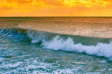 Sea waves on the beach at sunset