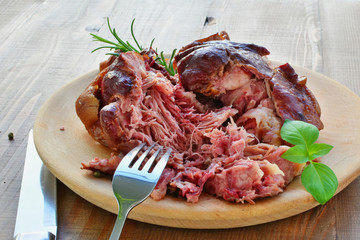 Smoked ham hock cooked, crock pot ham on wooden plate