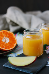 Glass filled by fresh mango and orange juice.