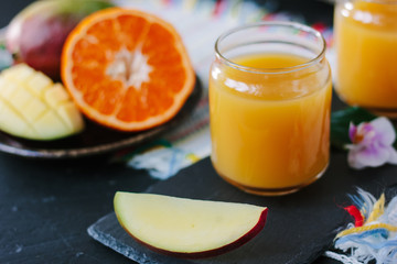 Glass filled by fresh mango and orange juice.