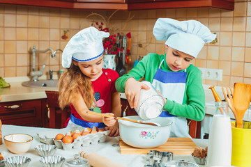 happy family funny kids are preparing the dough, bake cookies in the kitchen