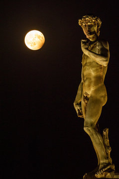 A Ball of Light, Piazzale Michelangelo, Florence, Tuscany, Italy, Europe Statue of David by Michelangelo the evening of the 7th August 2017 with the Full Moon at Partial Eclipse.