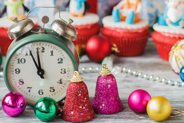 Old alarm clock near Christmas colored decorations