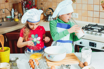 happy family funny kids are preparing the dough, bake cookies in the kitchen