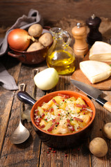 tartiflette, baked potato with cream,bacon and cheese