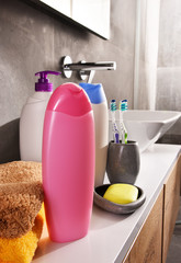 Plastic bottles of body care and beauty products in the bathroom