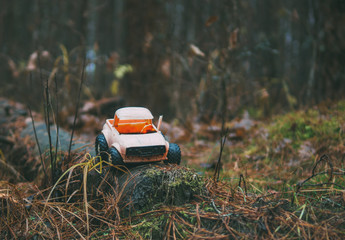old broken toy car in the woods
