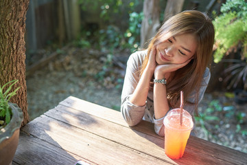 Beautiful asia woman relaxing with italian soda at the vintage coffee shop