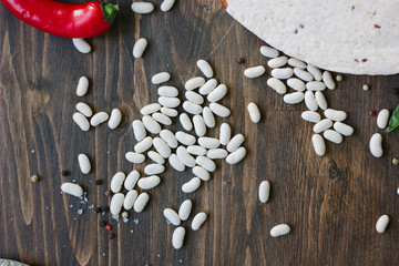 Dry white kidney beans on wooden table