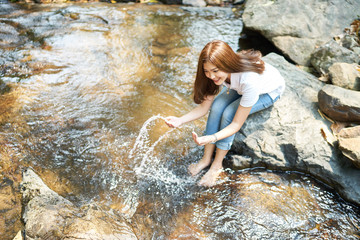 Beautiful woman playing and having fun time on the beautiful creek
