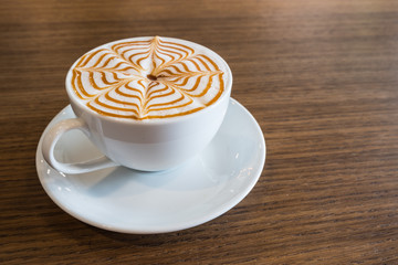 Cup of coffee latte art on wooden background