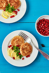 Roasted cauliflower meatballs with lemon and pomegranate on a blue background , top view. Healthy, vegetarian, dietary snack