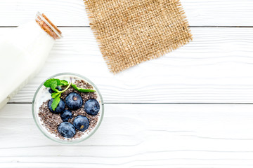 Eat chia seeds for breakfast with yogurt, blueberry and mint. White background top view copyspace