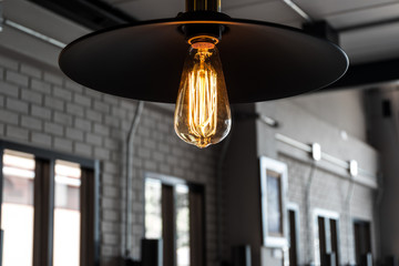 Warm hanging lamp from ceiling with loft interior style