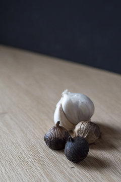 Two Types of Garlic on Wood Table