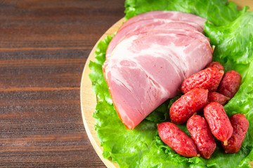 Assorted meat products including ham and sausages.