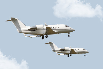 Fototapeta na wymiar Two corporate jets flying side by side