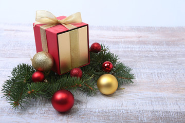 Christmas fir tree with gift box on wooden board