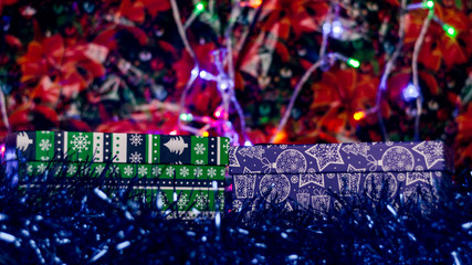 Boxes with presents for Christmas on a New Year's background.