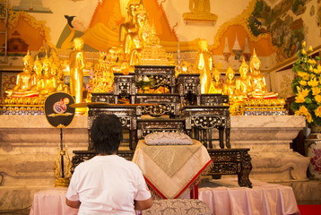 Praying buddhist at the temple in Bangkok.