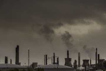 Dark sky above oil and gas industry.