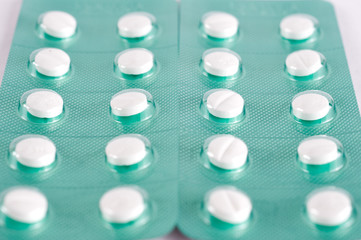 Different medicines. Tablets, pills in blister pack. Medications drugs. Pills over a white...