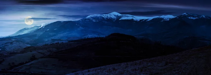 Foto op Plexiglas great mountain ridge Borzhava with snowy tops at night in full moon light. beautiful countryside landscape in late autumn © Pellinni