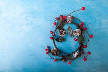 mistletoe wreath on blue background in studio photo