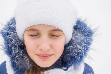 Close-up of girl in winter with snow
