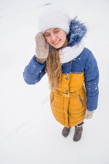 Happy teenager girl cover face from snow