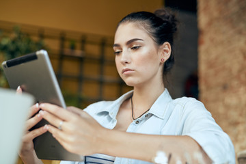 the girl is holding a tablet