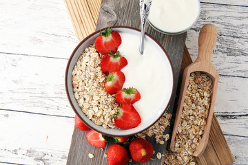 Bowl of homemade granola muesli with yogurt and fresh berries.