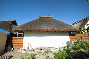 Fototapeta na wymiar Village house with thatched roof