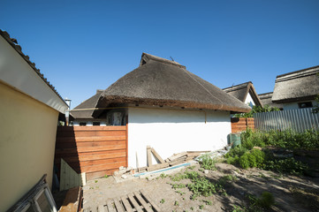 Fototapeta na wymiar Village house with thatched roof