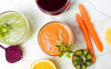Various smoothies with ingredients on a table